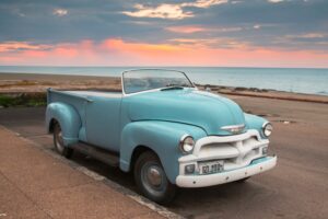 vintage car on the beach at sunset